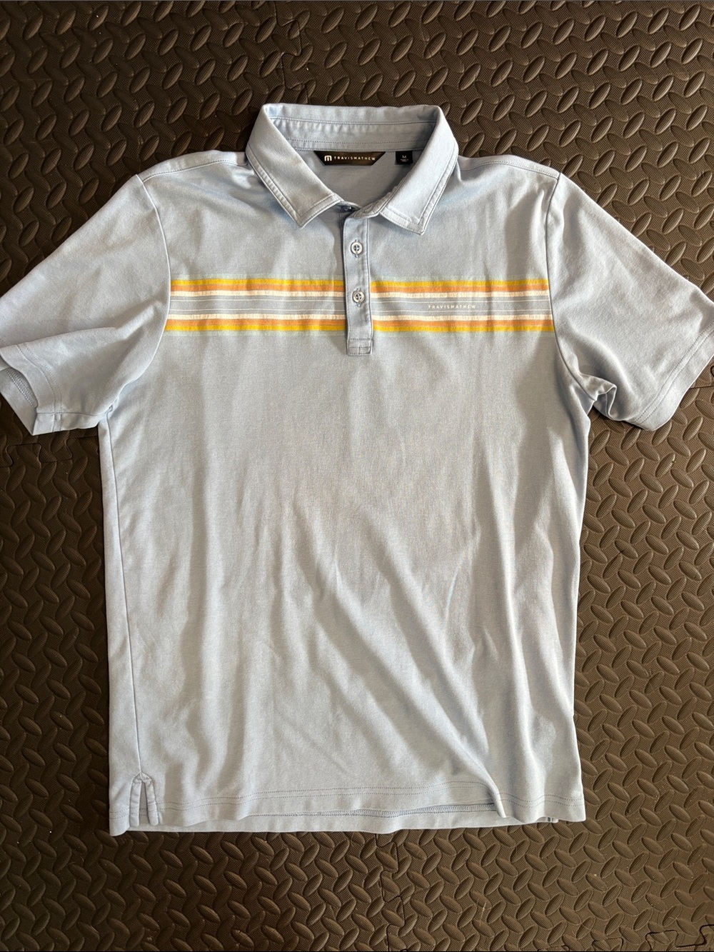 Travis Mathew Pale Blue Polo with Yellow and Orange Chest Stripes